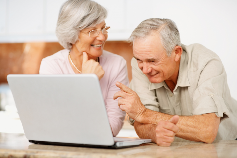 senior-man-and-woman-using-a-computer-laptop-niccss.png